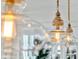 Close up of kitchen pendant lights with a warm, inviting glow and rustic wood and glass details at 3894 Sawyers Island Dr, Mount Pleasant, SC 29466