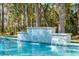 Close-up of the pool's waterfall feature with clear blue water and stone accents at 3894 Sawyers Island Dr, Mount Pleasant, SC 29466