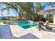 Luxurious backyard pool area with a waterfall feature, poolside seating, and well-maintained landscaping at 3894 Sawyers Island Dr, Mount Pleasant, SC 29466