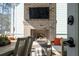 A brick fireplace with a mounted television highlights this cozy porch space at 3894 Sawyers Island Dr, Mount Pleasant, SC 29466