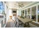 This spacious porch features a brick fireplace, ceiling fan, and an outdoor dining area at 3894 Sawyers Island Dr, Mount Pleasant, SC 29466