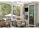 Comfortable covered porch with brick fireplace, television, and ample seating at 3894 Sawyers Island Dr, Mount Pleasant, SC 29466