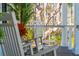 Relaxing porch with rocking chairs, a potted plant, and a view of the surrounding trees at 3894 Sawyers Island Dr, Mount Pleasant, SC 29466