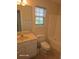 A bathroom with a marble sink and vanity, toilet, bathtub, and window at 399 Stefan Dr, Charleston, SC 29412