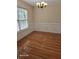 Bright dining room boasts hardwood floors, custom moldings, and a modern chandelier at 399 Stefan Dr, Charleston, SC 29412