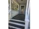 Inviting front porch featuring classic white railings, decorative columns, and a dark wood-stained floor at 399 Stefan Dr, Charleston, SC 29412