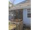 Covered screened porch features a ceiling fan and wood-railed perimeter, with lush greenery just beyond at 399 Stefan Dr, Charleston, SC 29412