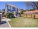 Expansive backyard boasts a lush lawn, privacy fence, storage shed, and mature landscaping at 4 Kenilworth Ave, Charleston, SC 29403