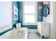 A serene bathroom featuring a soaking tub, white vanity, and soft, natural light at 4 Kenilworth Ave, Charleston, SC 29403