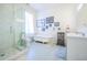 Bright bathroom with a glass shower, soaking tub, and decorative artistic details at 4 Kenilworth Ave, Charleston, SC 29403