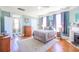 Bedroom featuring hardwood floors, fireplace, neutral colors, and great natural lighting at 4 Kenilworth Ave, Charleston, SC 29403