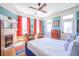 Bright bedroom featuring hardwood floors, fireplace, ceiling fan, and natural light at 4 Kenilworth Ave, Charleston, SC 29403
