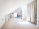 Bright bonus room with sloped ceilings features neutral carpet, a fitness area, and ample natural light at 4 Kenilworth Ave, Charleston, SC 29403