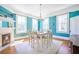 Bright dining room boasts a modern chandelier, fireplace, and ample natural light at 4 Kenilworth Ave, Charleston, SC 29403