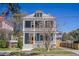 Charming two-story home with a large front porch, colorful door, and well-maintained landscaping at 4 Kenilworth Ave, Charleston, SC 29403