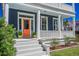 Charming home showcasing a colorful door, white columns, and well-manicured landscaping at 4 Kenilworth Ave, Charleston, SC 29403