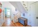 A bright hallway featuring hardwood floors, staircase, and view to the entry at 4 Kenilworth Ave, Charleston, SC 29403