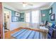 A sunlit home office featuring wainscoting, hardwood floors, and a view to the backyard at 4 Kenilworth Ave, Charleston, SC 29403