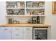 A well-organized pantry featuring custom shelving, ample storage, and a wine refrigerator at 4 Kenilworth Ave, Charleston, SC 29403