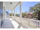 Spacious porch with white pillars and blue ceiling is great for outdoor relaxation at 4 Kenilworth Ave, Charleston, SC 29403