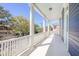 Relaxing porch with white pillars and blue ceiling has views of the neighborhood at 4 Kenilworth Ave, Charleston, SC 29403