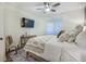 Cozy bedroom featuring a ceiling fan, tv, plantation shutters, and a plush patterned duvet at 400 Bucksley Ln # 103, Charleston, SC 29492