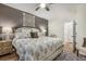 Relaxing bedroom with decorative wall art, plush patterned duvet, and wood floors at 400 Bucksley Ln # 103, Charleston, SC 29492