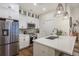 Beautiful kitchen featuring quartz countertops, stainless appliances, and classic white cabinets with glass inserts at 400 Bucksley Ln # 103, Charleston, SC 29492