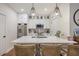Bright kitchen with a large island, stainless steel appliances, pendant lighting, and modern white cabinetry at 400 Bucksley Ln # 103, Charleston, SC 29492