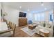 Stylish living room with a large TV, a cozy seating area, and an open transition to a dining space at 400 Bucksley Ln # 103, Charleston, SC 29492