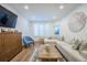 Comfortable living area with a cozy sectional, wood floors, natural light, and a classic wood cabinet at 400 Bucksley Ln # 103, Charleston, SC 29492