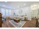 Relaxing living room featuring an oversized sofa, a charming coffee table, and views into the dining area at 400 Bucksley Ln # 103, Charleston, SC 29492