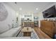 Bright living space with an open floor plan, wooden floors, a stylish couch, and a rustic coffee table at 400 Bucksley Ln # 103, Charleston, SC 29492
