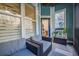 Cozy covered patio featuring comfortable seating and view of trees at 400 Bucksley Ln # 103, Charleston, SC 29492