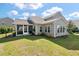Backyard features a screened-in porch, patio area, and lush green lawn, perfect for outdoor living and entertaining at 4021 Brown Trout Dr, Johns Island, SC 29455