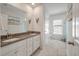 Bright bathroom features double sink vanity with granite countertops, tile floors, and beach-themed decor at 4021 Brown Trout Dr, Johns Island, SC 29455