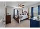Comfortable bedroom boasts a four-poster bed, ceiling fan, and neutral carpet for a restful retreat at 4021 Brown Trout Dr, Johns Island, SC 29455