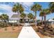 Paver walkway leading to gated pool with palm trees, bathrooms and cabana at 4021 Brown Trout Dr, Johns Island, SC 29455