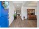 Bright and welcoming foyer with hardwood floors and blue door at 4021 Brown Trout Dr, Johns Island, SC 29455