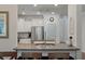 Granite bar with view to the kitchen with stainless steel appliances and pantry at 4021 Brown Trout Dr, Johns Island, SC 29455