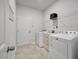 Functional laundry room with modern washer, dryer, storage cabinet and door to the outside at 4021 Brown Trout Dr, Johns Island, SC 29455