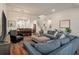 Expansive living space features hardwood floors, a large sectional, and an adjacent dining area for entertaining at 4021 Brown Trout Dr, Johns Island, SC 29455