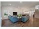Open-concept living area with hardwood floors, large windows, a view to the kitchen, and a dining space at 4021 Brown Trout Dr, Johns Island, SC 29455