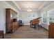 Elegant living area featuring hardwood floors, coffered ceiling, and a grand piano at 4021 Brown Trout Dr, Johns Island, SC 29455