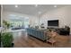 Spacious living room with hardwood floors, vaulted ceilings, comfortable seating, and a large TV at 4021 Brown Trout Dr, Johns Island, SC 29455