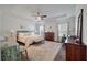 Bright and airy main bedroom boasts tray ceilings, large windows, and elegant furnishings at 4021 Brown Trout Dr, Johns Island, SC 29455
