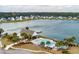 Community pool with lake view, palm trees and ample seating, perfect for relaxation and social gatherings at 4021 Brown Trout Dr, Johns Island, SC 29455