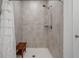 Bright shower with tiled walls, rain shower head, and a convenient wooden bench at 4021 Brown Trout Dr, Johns Island, SC 29455