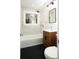 Modern bathroom features a vanity, toilet, tub and shower with stylish patterned tile and updated lighting at 412 Arlington Dr, Charleston, SC 29414