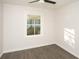 Bright bedroom featuring a ceiling fan, modern gray vinyl floors, and a window providing ample natural light at 412 Arlington Dr, Charleston, SC 29414